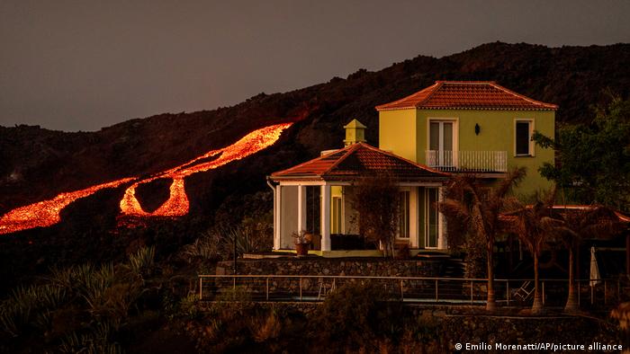 A stream of lava and a house