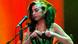 Amy Winehouse performing with a green dress. Amy Winehouse performing with a green dress.