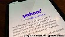 A smart phone shows the home page of Yahoo when accessed inside China in Beijing, China, Tuesday, Nov. 2, 2021. Yahoo Inc. on Tuesday said it plans to pull out of China, citing an increasingly challenging business and legal environment. (AP Photo/Ng Han Guan)
