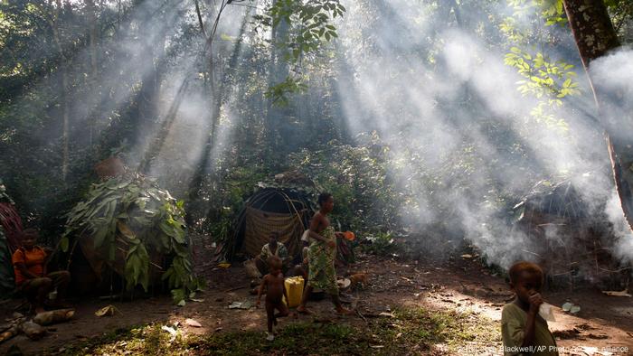 Indigenous people in a forest.