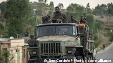 Ethiopian government soldiers ride in the back of a truck on a road leading to Abi Adi, in the Tigray region of northern Ethiopia Tuesday, May 11, 2021. (AP Photo/Ben Curtis)