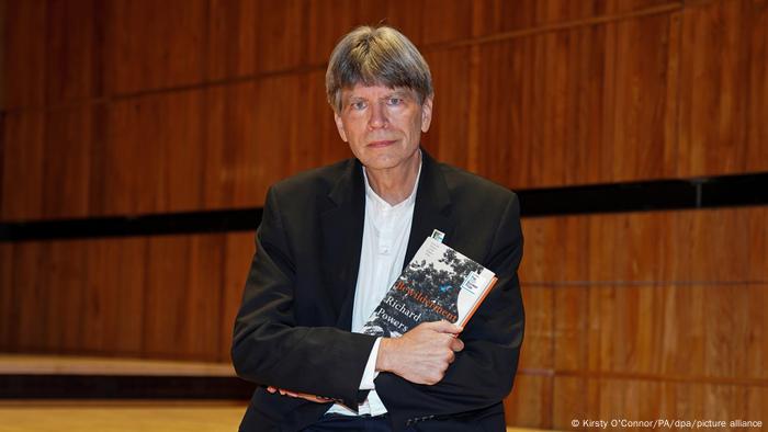 Author holds his book