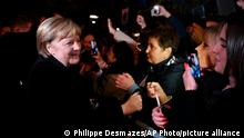German Chancellor Angela Merkel greets residents before her meeting with French President Emmanuel Macron in Beaune, Burgundy, Wednesday Nov. 3, 2021. German Chancellor Angela Merkel will be feted by France in a special farewell ceremony honoring her leadership and partnership. Merkel is leaving office after 16 years in power. (Philippe Desmazes, Pool Photo via AP)