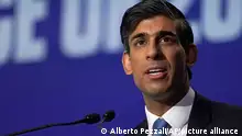 Britain's Chancellor of the Exchequer Rishi Sunak makes a speech at the COP26 U.N. Climate Summit in Glasgow, Scotland, Wednesday, Nov. 3, 2021. The British government plans to make the U.K. the world's first net-zero aligned financial center as companies and investors seek to profit from the drive to build a low-carbon economy. Sunak will lay out the government's plans during a speech Wednesday as top financial officials from around the world meet at the U.N. climate conference in Glasgow, Scotland. (AP Photo/Alberto Pezzali)