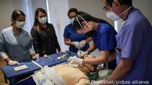 (200415) -- BOGOTA, April 15, 2020 () -- Medical workers attend a treatment drill as part of efforts to fight against the COVID-19 pandemic in Bogota, Colombia, April 14, 2020. (Photo by Jhon Paz/)