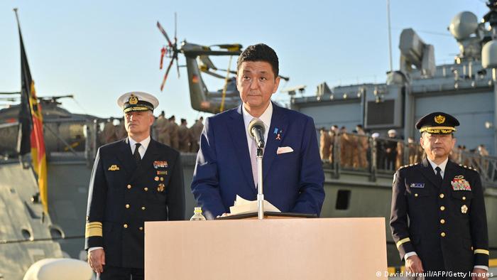 Japan's Defense Minister Nobuo Kishi (C) speaks at a press conference during a visit to the German Navy frigate Bayern in Tokyo