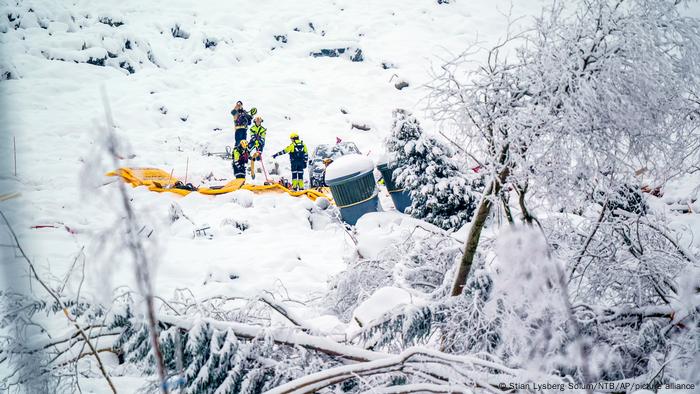 Rescue crews search for missing people at the scene of a landslide in Ask, Norway