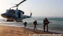 In this picture released by the Iranian Army on Saturday, Nov. 7, 2021, troops attend a maneuver in a coastal area in southeastern Iran. Iran's military began its annual war games in the coastal area of the Gulf of Oman, Sunday, less than a month before upcoming nuclear talks with the West. (Iranian Army via AP)