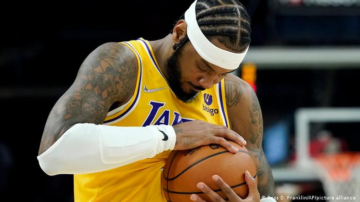 Carmelo Anthony in the Los Angeles Lakers jersey holds and strokes the ball
