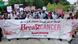 People hold a breast cancer awareness banner in English and Urdu People hold a breast cancer awareness banner in English and Urdu