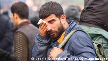  BELARUS - NOVEMBER 8, 2021: A man wipes his face the Belarusian-Polish border. Nearly 1,000 refugees were heading towards the Polish border in the morning of November 8, 2021. The foreigners intend to exercise their right to apply for a refugee status in an EU country. Poland s troops in the border regions were put on full alert. Leonid Shcheglov/BelTA/TASS PUBLICATIONxINxGERxAUTxONLY TS117278