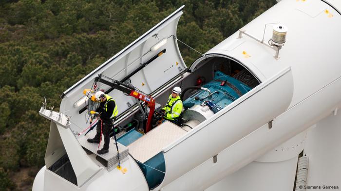 Two technicians check a Siemens wind turbine in Northern Morocco 