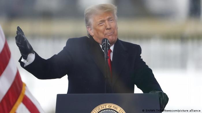 President Donald Trump giving a speech at a podium