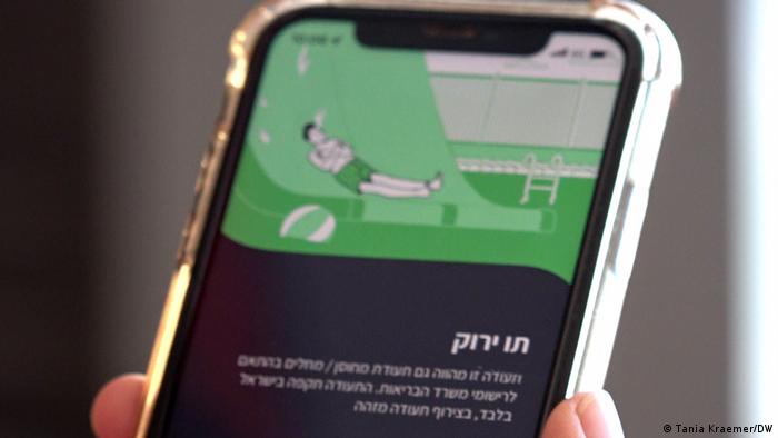 Person showing green pass on smartphone app at Ben Gurion airport