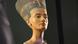 The bust of Nefertiti, seen from the left and below, against a black background The bust of Nefertiti, seen from the left and below, against a black background
