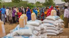 Ethiopians queue to receive aid distributed under a European Union (EU) funded project, in the Shinile Zone of Ethiopia Friday, April 8, 2016, near the border with Somalia. According to the European Commission, the EU has announced 122.5 million euros in aid to address the immediate needs of people affected by a worsening humanitarian and drought situation in Ethiopia. (AP Photo/Mulugeta Ayene)