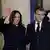 US Vice President Kamala Harris and French President Emmanuel Macron wave at reporters at the Elysee Palace in Paris