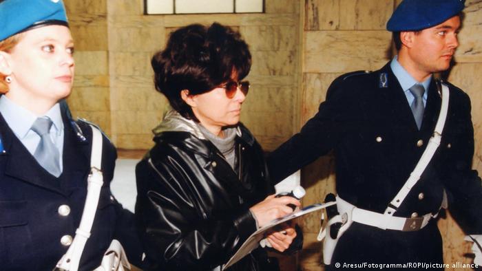 Patrizia Reggiani, ex-wife and widow of Maurizio Gucci being led off by two Italian police officers