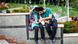 An Iranian couple sits on a wall and fiddles with their mobile phones An Iranian couple sits on a wall and fiddles with their mobile phones