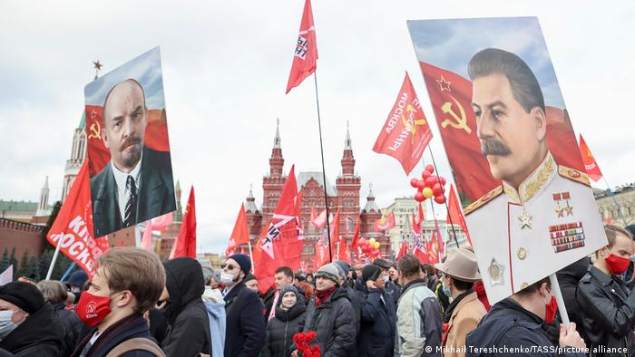 Supporters of the Russian Communist Party take part in a flower and wreath laying ceremony by Lenin's Mausoleum in Red Square and a memorial complex to Heroes of the Revolution by the Kremlin Wall, to mark the104th anniversary of the 1917 October Revolution last Sunday
