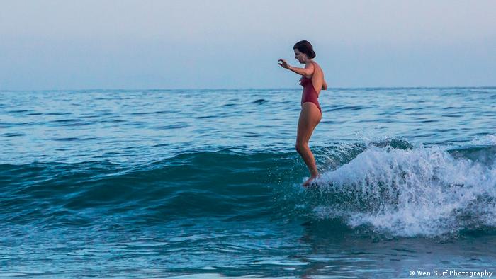 Lucy Small surfing
