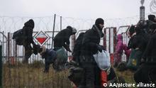 BELARUS - NOVEMBER 12: Irregular migrants continue to wait at the Polish-Belarusian border on November 12, 2021 in Belarus. Thousands of irregular migrants are facing desperate conditions as they continue waiting at the Polish-Belarusian border, hoping to cross onto EU soil. After crossing the Bruzgi border point in Grodno, Belarus on Monday, the immigrants Äì most of them from Iraq Äì came to the Polish border to spend Tuesday night. Nearly 2,000 immigrants, including many women and children, stayed in tents they set up in front of the border fences in the forested area. Stringer / Anadolu Agency