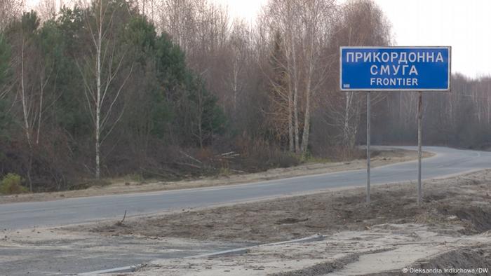 Lonely road and sign indicating the border of Ukraine with Belarus Poland