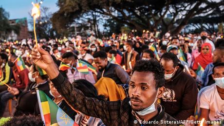 A demonstrator in Addis Ababa holds a candle during a memorial service for victims of the Tigray conflict
