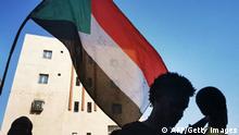 TOPSHOT - Sudanese youths wave a national flag as they protest in the streets of the capital Khartoum, amid ongoing demonstrations against a military takeover that has sparked widespread international condemnation, on November 4, 2021. (Photo by AFP) (Photo by -/AFP via Getty Images)