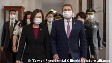 In this photo released by the Taiwan Presidential Office, outgoing Honduran President Juan Orlando Hernandez, front right, walks with Taiwanese President Tsai Ing-wen during a meeting in Taipei, Taiwan Saturday, Nov. 13, 2021. Hernandez started a three-day surprise visit to Taiwan on Friday as the self-ruled island, which is also claimed by China, worries that the next president of the Central American nation may break off relations and switch to diplomatic ties with Beijing. (Taiwan Presidential Office via AP)