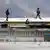 Armed police walk on the roof of the Ecuador prison where the latest riots took place