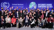 Delegates pose for a picture during the UN Climate Change Conference (COP26) in Glasgow, Scotland, Britain November 13, 2021. REUTERS/Yves Herman