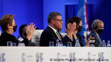 Britain's Alok Sharma, second left, President of the COP26 and Patricia Espinosa, left, UNFCCC Executive-Secretary applaud during the closing plenary session at the COP26 U.N. Climate Summit, in Glasgow, Scotland, Saturday, Nov. 13, 2021. Government negotiators from nearly 200 countries have adopted a new deal on climate action after a last-minute intervention by India to water down the language on cutting emissions from coal.(AP Photo/Alberto Pezzali)