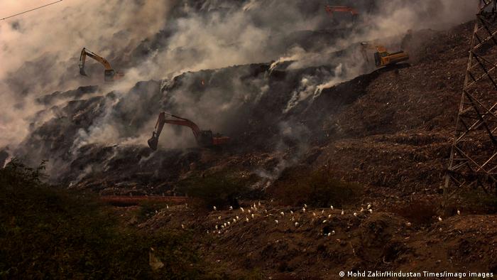 A huge plume of smoke seen rising from the waste mountain after its catch fire at the Ghazipur landfill site