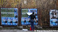 A man pastes election posters in Haskovo, Bulgaria, November 8, 2021. Picture taken November 8, 2021. REUTERS/Stoyan Nenov
