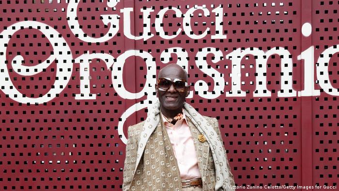 Dapper Dan wearing a suit emblazoned with the luxury brand's logo