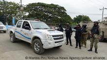 (211114) -- GUAYAQUIL, Nov. 14, 2021 (Xinhua) -- Police officers stand guard outside the Litoral Penitentiary after clashes occurred in the prison in Guayaquil, Ecuador, Nov. 13, 2021. The death toll from the clashes at the Litoral Penitentiary in the Ecuadorian city of Guayaquil has risen to 68, the State Attorney General's Office reported on Saturday. The clashes occurred on Friday night and early on Saturday and left an initial balance of 58 dead and 12 injured, according to a previous report from the police and the Guayas provincial government. The police said that the clashes were the result of a power struggle between groups linked to drug trafficking. (Photo by Marcos Pin/Xinhua)