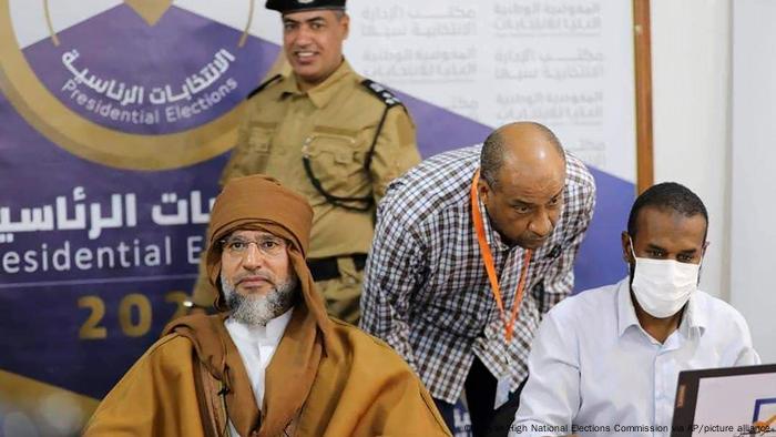 Seif al-Islam, left, the son of Moammar Gadhafi registers his candidacy for the country’s presidential elections 