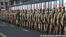 FILE PHOTO: Azeri service members take part in a procession marking the anniversary of the end of the 2020 military conflict over Nagorno-Karabakh breakaway region, involving Azerbaijan's troops against ethnic Armenian forces, in Baku, Azerbaijan, November 8, 2021. REUTERS/Aziz Karimov/File Photo