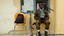 FILE PHOTO: A soldier with the Tigrayan forces reads a book as he guards the headquarters of the Tigrai Mass Media Agency in Mekelle, the capital of Tigray region, Ethiopia, July 7, 2021. REUTERS/Giulia Paravicini/File Photo