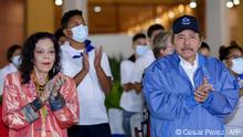 (FILES) In this file photo taken on November 08, 2021 Handout picture released by the Nicaraguan presidency showing Nicaragua's President Daniel Ortega (R) and his wife and Vice-president Rosario Murillo applauding during the commemoration of the 45th anniversary of the death of one of the founders of the Sandinista National Liberation Front (FSLN) guerrilla, Carlos Fonseca, in Managua. - The United States on November 16, 2021 imposed an entry ban on Nicaraguan President Daniel Ortega, his vice-president wife and his government, after elections that were internationally dismissed as illegitimate. (Photo by Cesar PEREZ / Nicaraguan Presidency / AFP) / RESTRICTED TO EDITORIAL USE - MANDATORY CREDIT AFP PHOTO / NICARAGUAN PRESIDENCY / CESAR PEREZ - NO MARKETING - NO ADVERTISING CAMPAIGNS - DISTRIBUTED AS A SERVICE TO CLIENTS