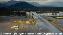 Rising flood water surround a home and cover Highway 1 in Abbotsford, British Columbia, Tuesday, Nov. 16, 2021. Abbotsford Mayor Henry Braun said impassable highways were creating havoc in his city as police and firefighters tried to get people to evacuation centers. Sunny skies followed two days of torrential storms that dumped the typical amount of rain that the city gets in all of November, but the mayor said the water was still rising and Highway 1 would be cut shut down for some time. (Jonathan Hayward/The Canadian Press via AP)
