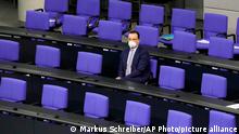 CORRECTS DATE -- German health minister Jens Spahn has taken his seat for a parliament Bundestag session about new measures to battle the coronavirus pandemic at the Reichstag building in Berlin, Germany, Thursday, Nov. 18, 2021. (AP Photo/Markus Schreiber)