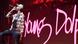 Rapper Young Dolph singing into a microphone with his name written in pink in the backgound. Rapper Young Dolph singing into a microphone with his name written in pink in the backgound.