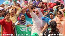 March 8, 2021, New Delhi, India: Indian women farmers from Haryana and Punjab seen seated on the roadside while shouting anti-government slogans at the protest sites Tikri border (Delhi-Haryana Border) during ongoing protest against the Centers new agricultural laws..Thousands of women farmer and family member of farmers gathered at Delhi borders on the International Women Day. (Credit Image: © Naveen Sharma/SOPA Images via ZUMA Wire