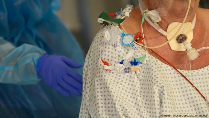 Image of a patient's shoulders and neck with various medical access lines 