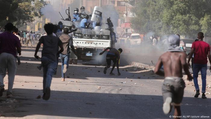 Sudanese confront the police during a protest against the military coup