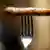 A bratwurst on a fork