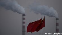 3.11.2021***China's national flags flutter in front of a coal-powered power station in Datong, China's northern Shanxi province on November 3, 2021. (Photo by Noel Celis / AFP)