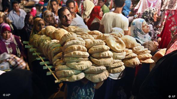 An Egyptian boy carries a load of bread at a popular market in Cairo, Egypt